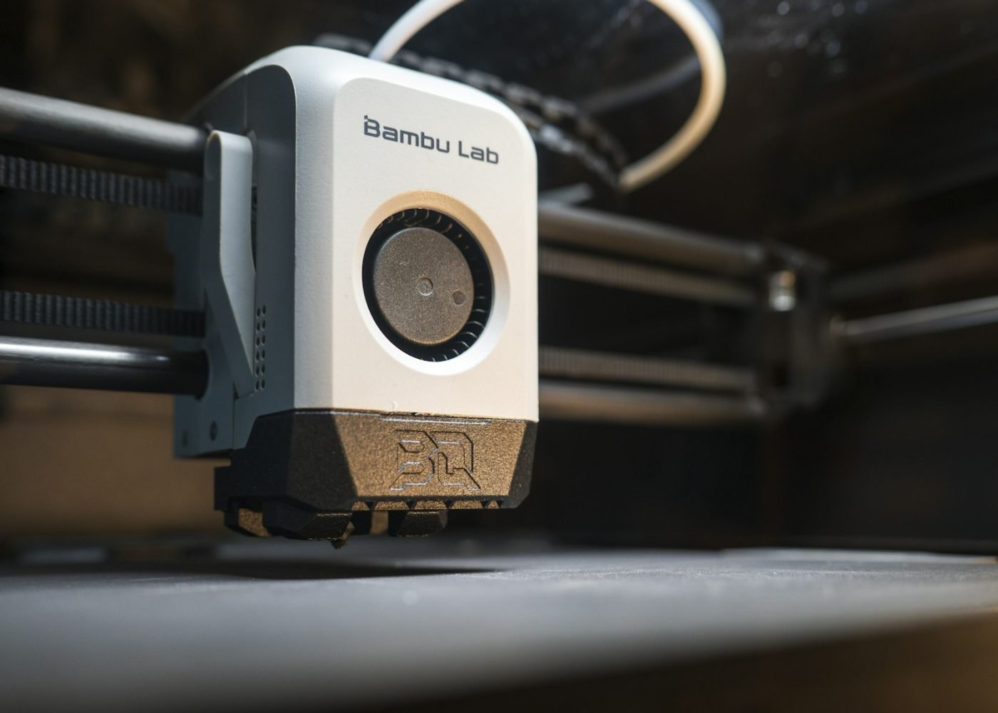 Close-up of a printer toolhead moving over the build plate